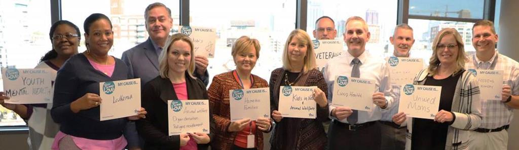 GSA Heartland Region senior managers pose for a photo with signs showing their CFC causes.