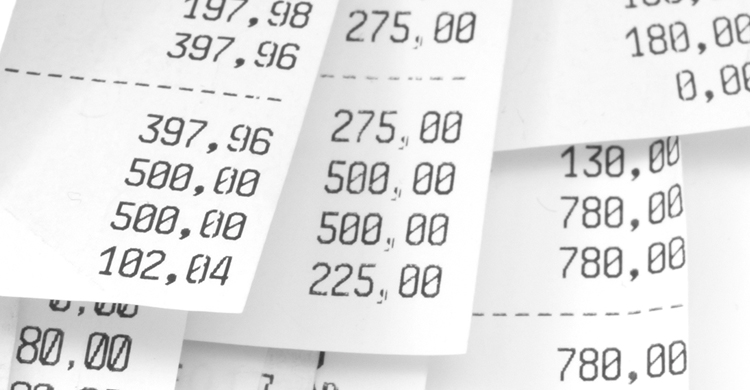 Close-up of paper receipts with random tallies of numbers