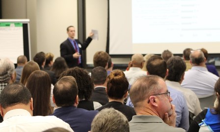 GSA’s Eric Stonner (background) presents to Schedule 03FAC vendors March 13.
