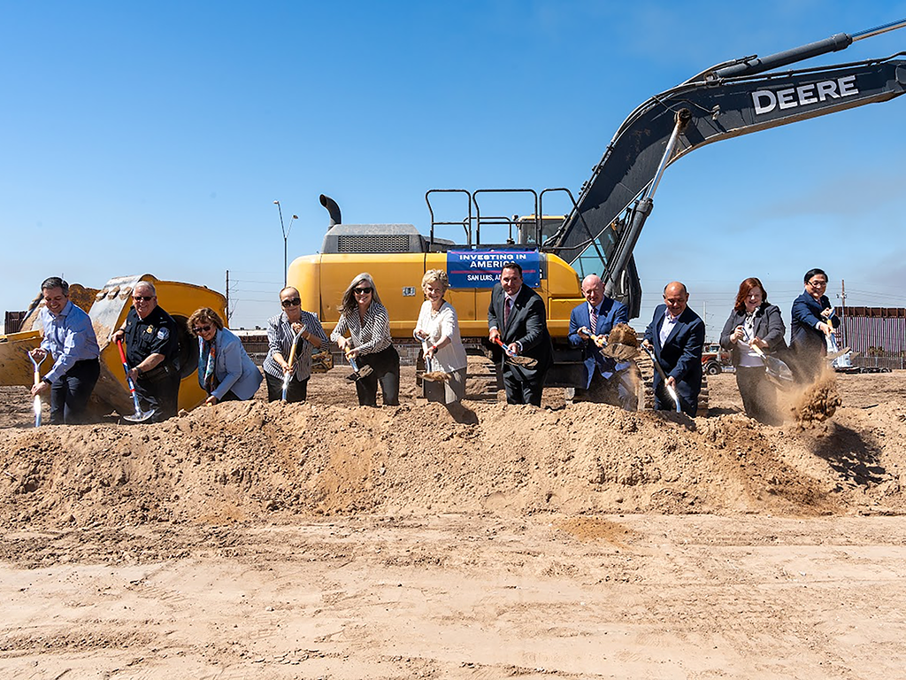 San Luis Ground Breaking Attendees in front of a back hoe, shoveling dirt to represent the Greound Breaking