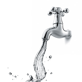 Silver sink faucet with water flowing - white background