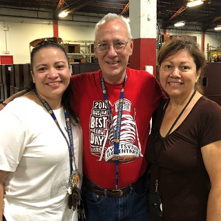 Teachers pose at te furniture for schools event hosted by FAS