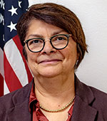 Smiling woman in glasses and short brown hair