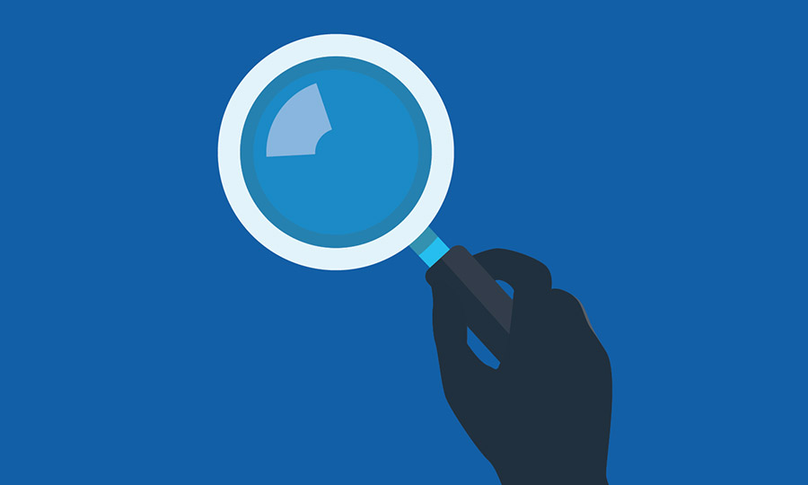 Illustration of hand holding a magnifying glass