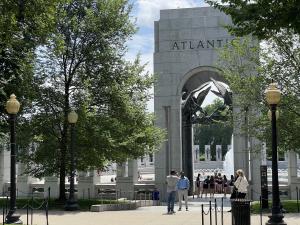 People taking photos in front of the WWII memorial in Washington, DC.