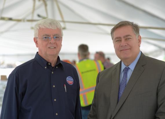 EPA Regional Administrator and GSA Regional Administrator pose for a photo under a tent at a luncheon
