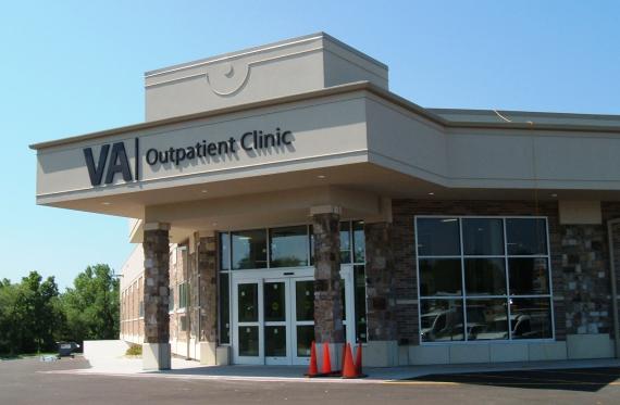 The exterior of a building with a sign that says &quot;VA outpatient clinic&quot; in black letters