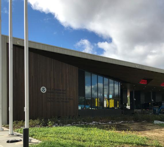 Front view of the Derby Line LPOE with traffice lanes to the right of large windows