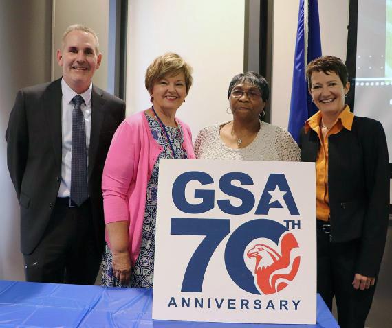 Kevin Rothmier, Judy Dungan, Gwendolyn Smith, and Mary Ruwwe with GSA at 70 sign.