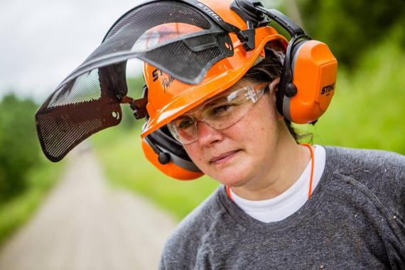 Jaime Habersat wearing an orange sawyer hat with face shield and ear protection as part of her job with Team Rubicon.
