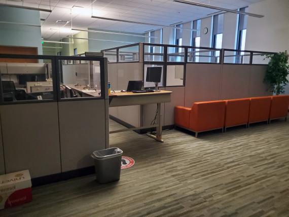 An adjustable desk blocks visitors from passing through the main hallway in the Kansas City North Field Office — one of many soc