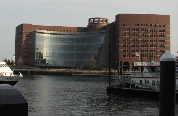 the moakley courthouse with a wall of windows showing across the boston harbor