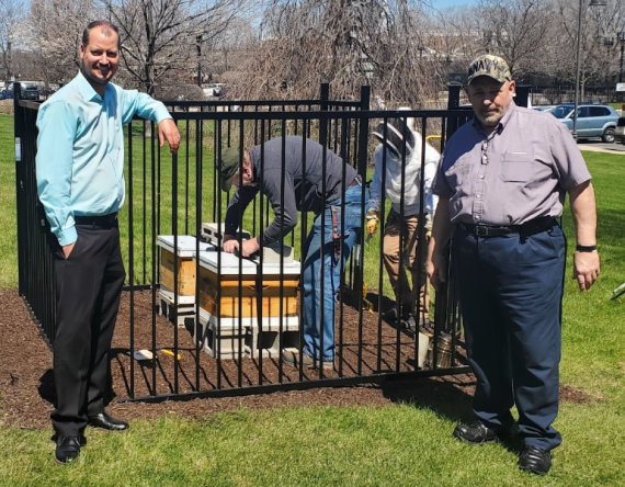 Medium shot of property manager Josh Westhouse and Rich Falzone outside the new bee hive enclosure
