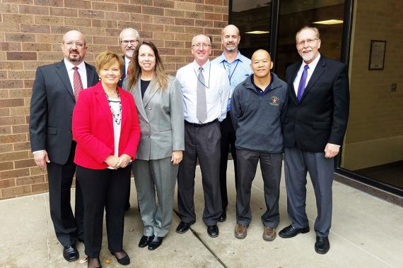 Seven GSA employees pose for a photo standing with U.S. Rep. Dave Loebsack of Iowa