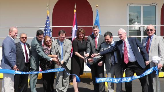 Dignitaries cut the ribbon to mark the completion of construction on the new CBP lab located at the GSA Center in Guaynabo