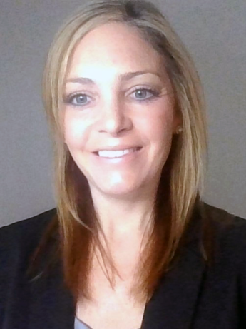 Tight portrait of person in black business jacket, smiling.