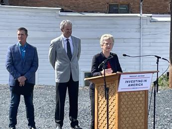 Robin Carnahan delivers remarks at a podium with Butte officials in the background