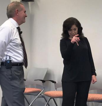 Brenda Lee Ladage gestures to members of the audience at her retirement reception.