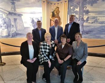 Group of 7 in business casual attire in Courthouse