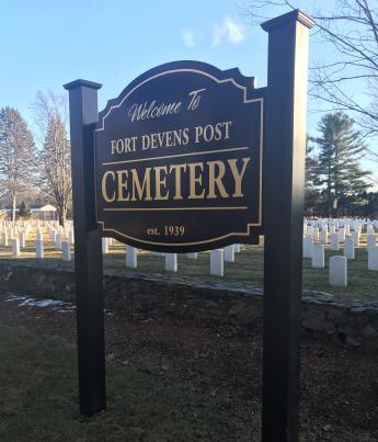 sign that says fort devens post cemetery