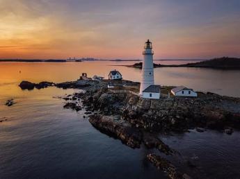 Lighthouse with a sunset behind it