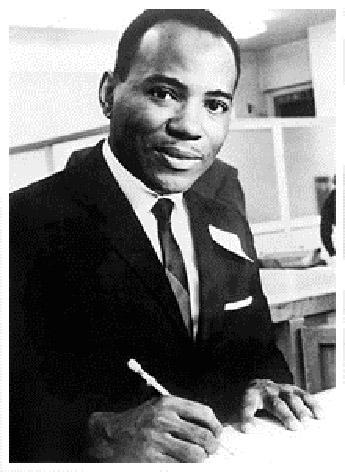 James Meredith at his desk, pen in hand