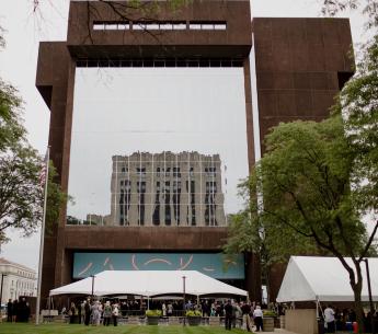 Full front shot of Rice Federal Building and U.S. Courthouse with ceremony tents in foreground.