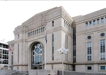 exterior of the courthouse building with lampposts in front