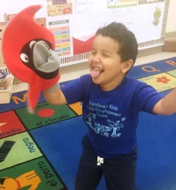 Sebastian Perez, 4, plays with a puppet named Hurry, which educators at the Rainforest Kids Child Development Center used to exp