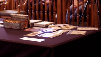 Artifacts from the original time capsule on display for the audience.