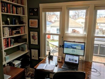 Photo of a home office, with the desk facing a window.