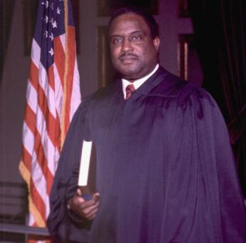 Judge Joseph Woodrow Hatchett, a black man in a judge's robe holding a book