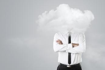 Person in a tie standing with head obscured by cloud