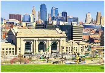 Cranes and the frame to a large stage fill the space in front of Union Station with Downtown KC in the backdrop.