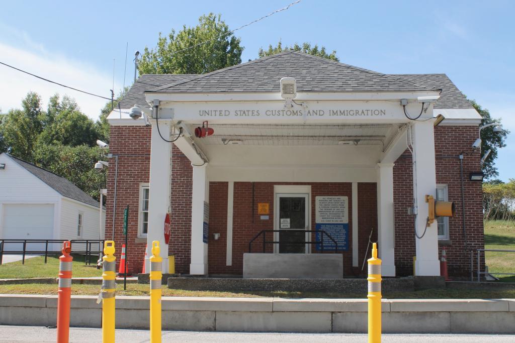 The brick building with an overhang for the cars