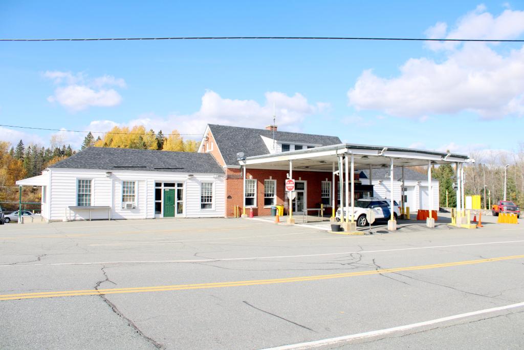 A white garage attached to a brick building