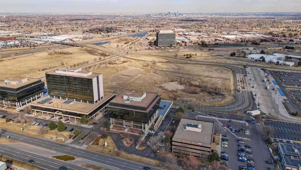 2 Looking east. Businesses along Union Blvd. in the foreground, showing downtown Denver to the east and 6th Avenue West highway 