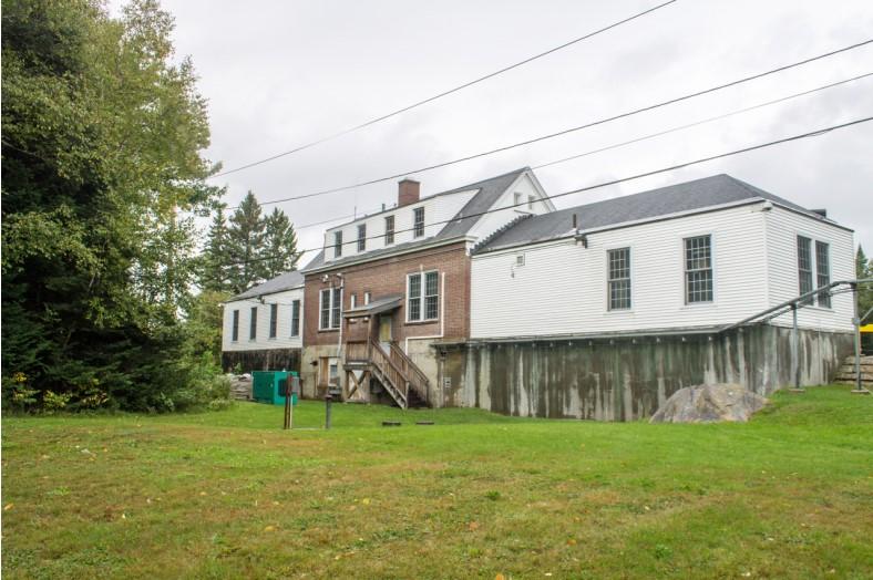The back of the port with a grassy hill leading up to the building