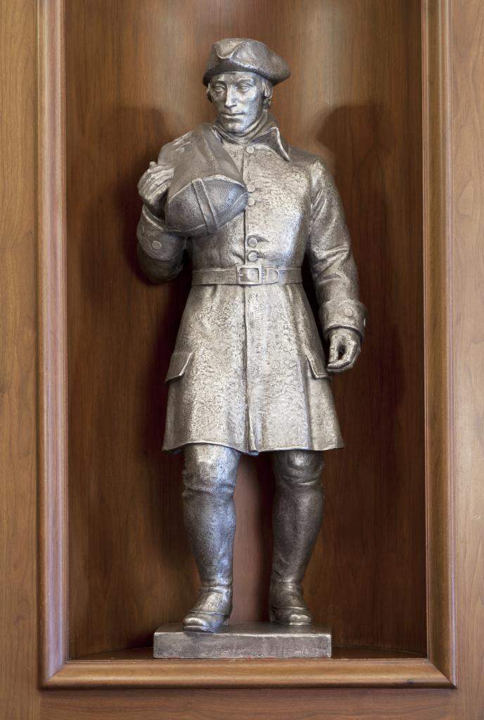 aluminum sculpture of a foot postman from the colonial era