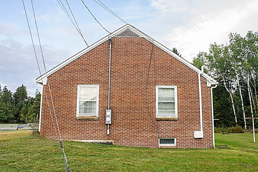 one story brick building with two windows
