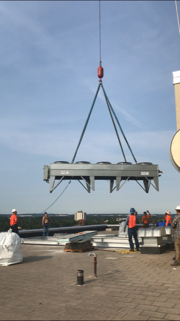 Dry chiller being lowered on roof 