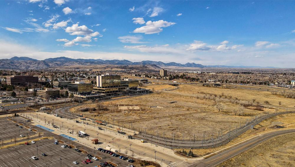 1 Looking northwest. RTD Park and Ride in foreground_ Businesses along Union Blvd. and the foothills in the background.