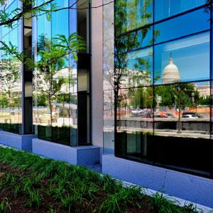 The new glass curtain wall reflects scenes from around the building, showing off its premiere location near the U.S. Capitol.