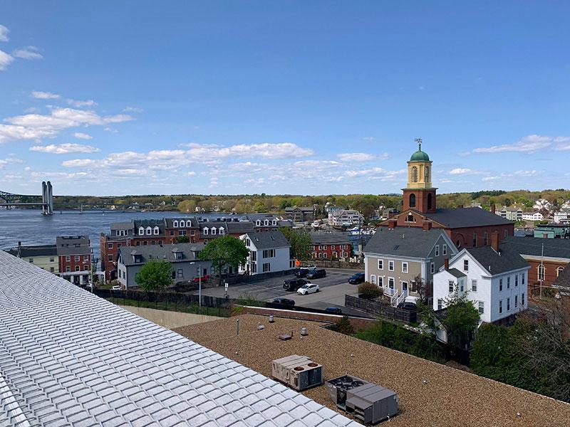 View of buildings, a church, trees, and a river in Portsmouth, New Hampshire.