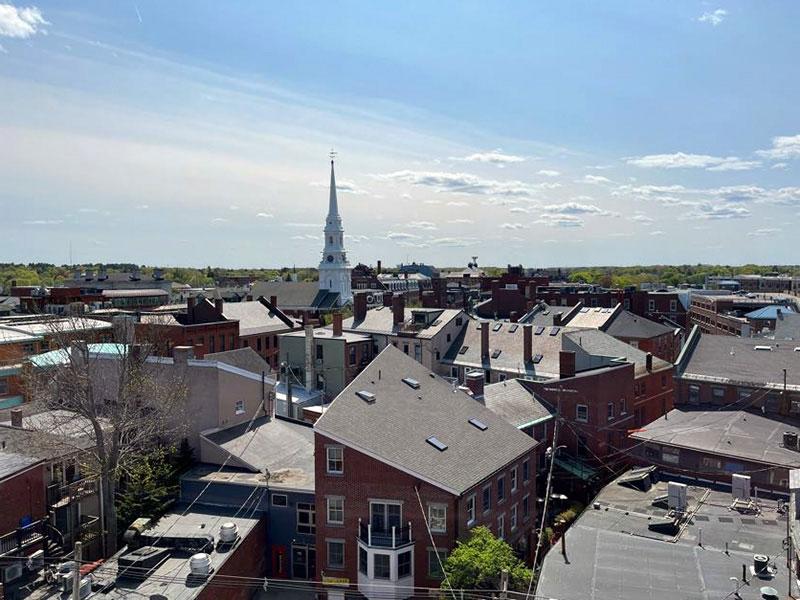 View of rooftops and a white church spire in Portsmouth, NH.