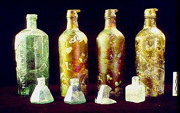 Irish Tenement and Saloon Artifact - 19th-century glass ink bottles; master inks (rear), three umbrella bottles (left front), and a rectangular embossed bottle from T.DAVIDS of New York (right front).