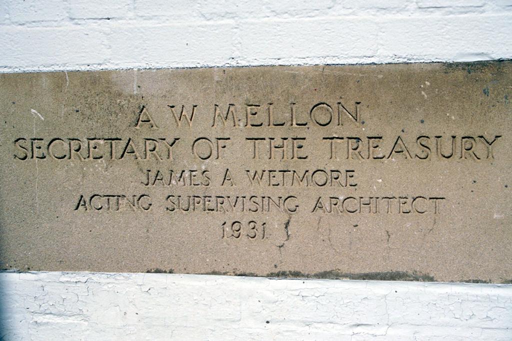 Stone in a brick wall with the carved text AW Mellon, Secretary of the Treasury, James A Wetmore, Acting Supervising Architect, 1931
