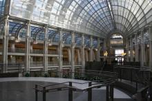 The interior of the Ronald Reagan building in DC, with an overlook with rows of columns and glass windows